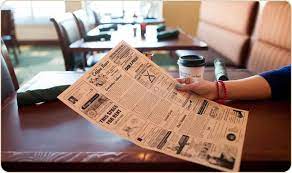 customer reading coffee news at restaurant